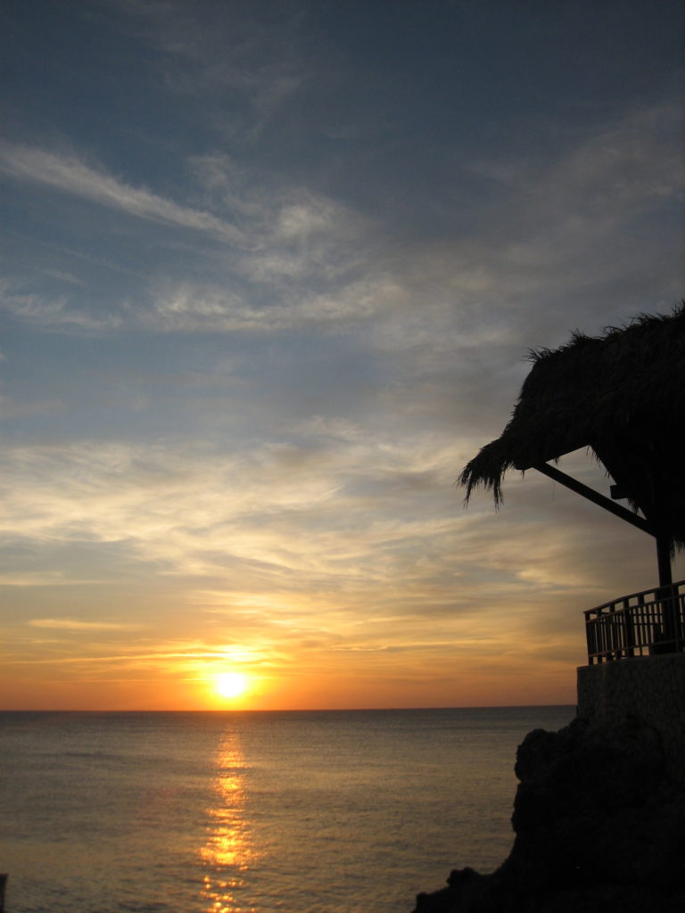 Rick's café Sunset - must stop by for a cocktail and watch the sunset if you are in Negril Jamaica | Outside Suburbia