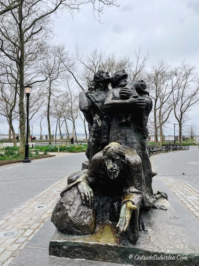 The Immigrants sculpture at Battery Park depicts figures of various ethnic groups and eras, including an Eastern European Jew, a freed African slave, a priest, and a worker.